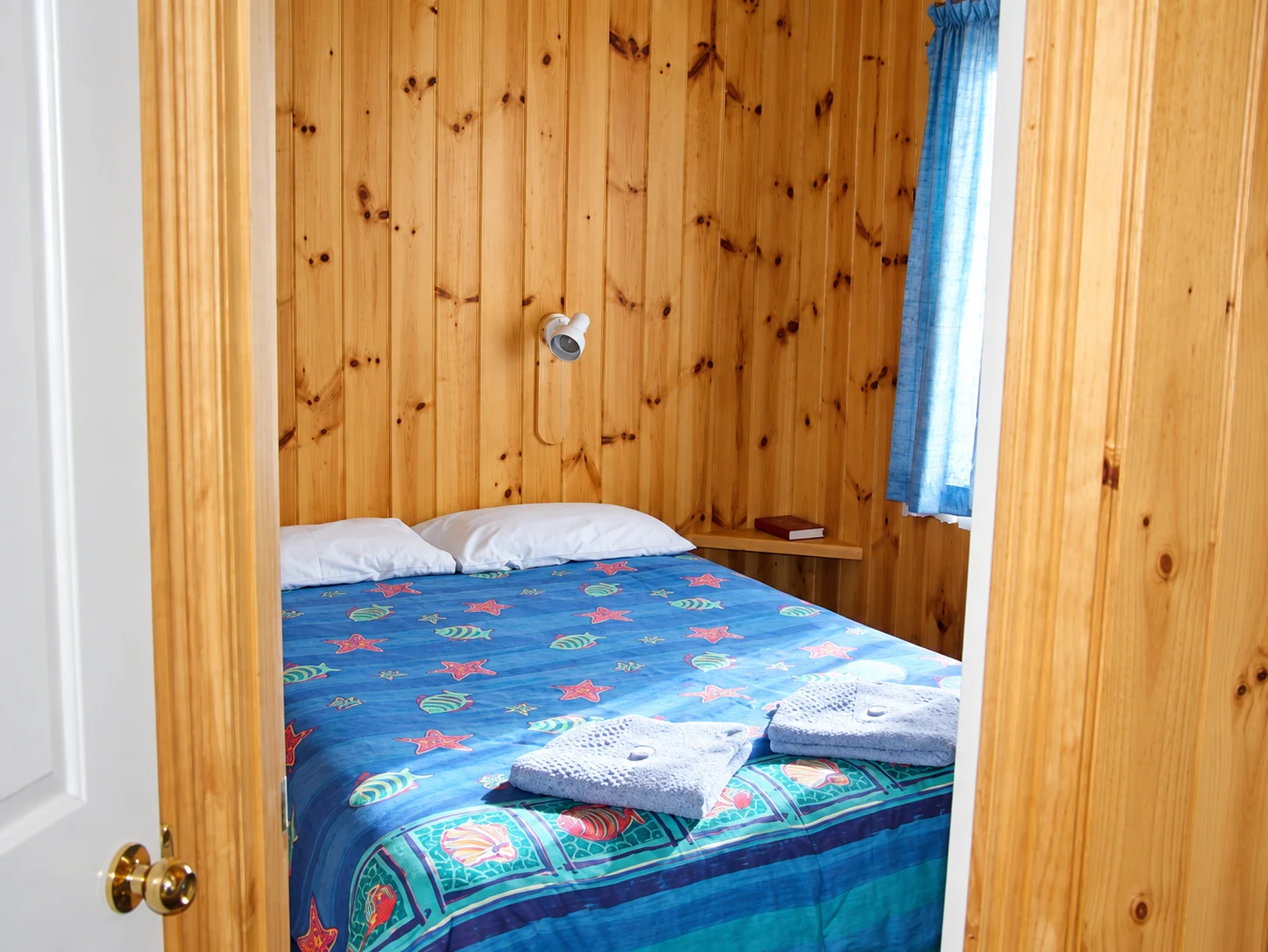 One-bedroom cabin bedroom — enhanced from the booking gallery