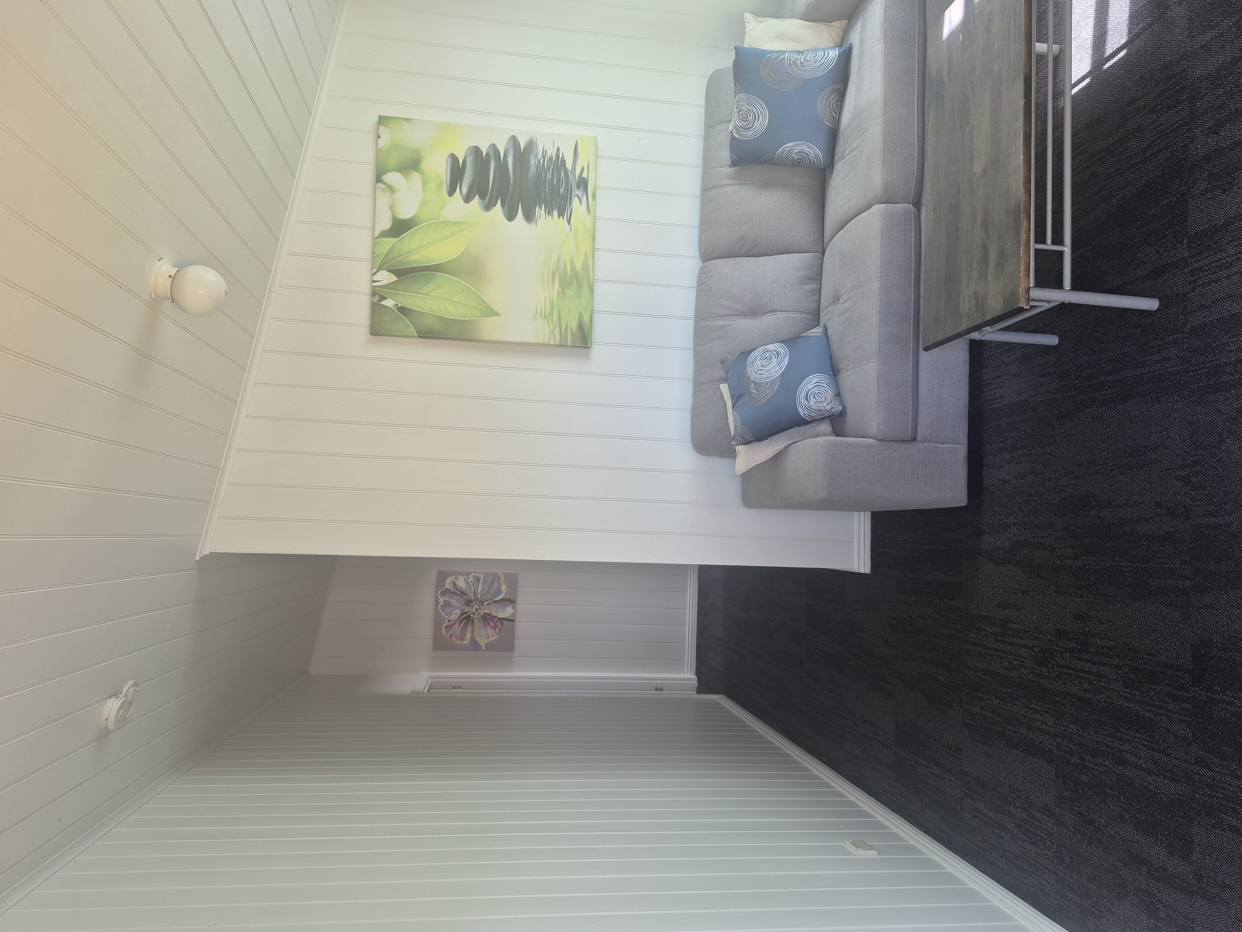 A sofa and coffee table in the two-bedroom cabin lounge